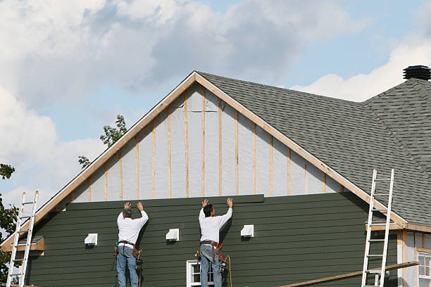 Professional Storm Damage Siding Repair technician working in Holtsville, NY